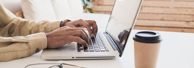 header image of man typing on computer